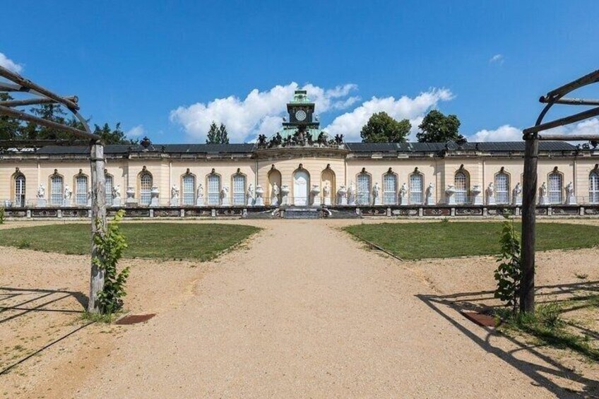 A classical building with arched windows and a central clock tower. 4