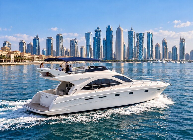 A white yacht cruising on water with a city skyline in the background. 1