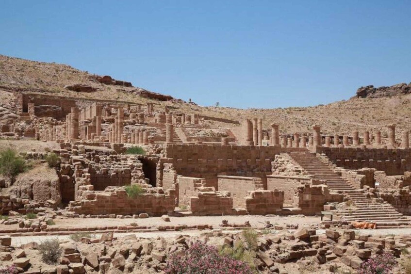 Ancient ruins with stone columns and a staircase. 2