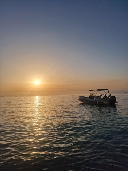 A boat on calm water during sunset. 2