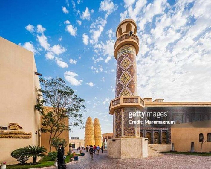 A mosque with a tall minaret and a courtyard. 4