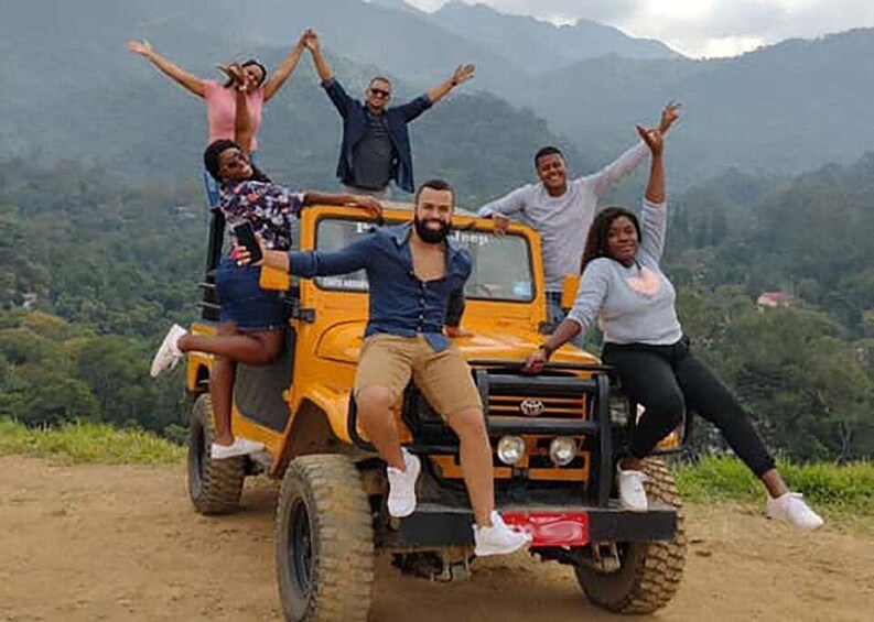 A group of people on a yellow off-road vehicle in a mountainous area. 5