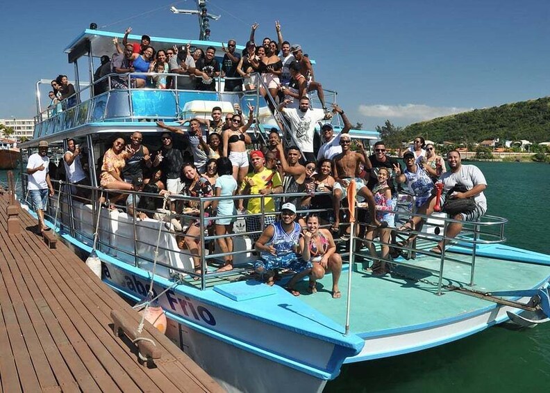 A group of people on a blue boat with a wooden deck. 4