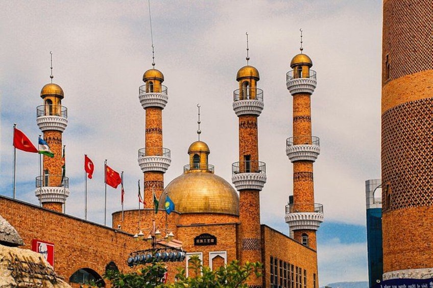 A mosque with multiple minarets and a golden dome. 4