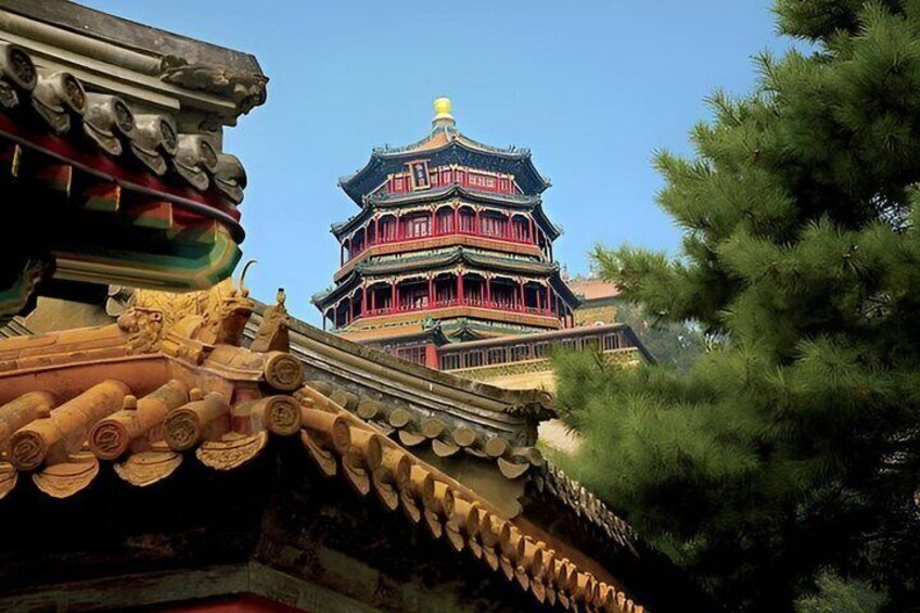 A traditional multi-tiered pagoda with ornate roof tiles and a clear blue sky. 2