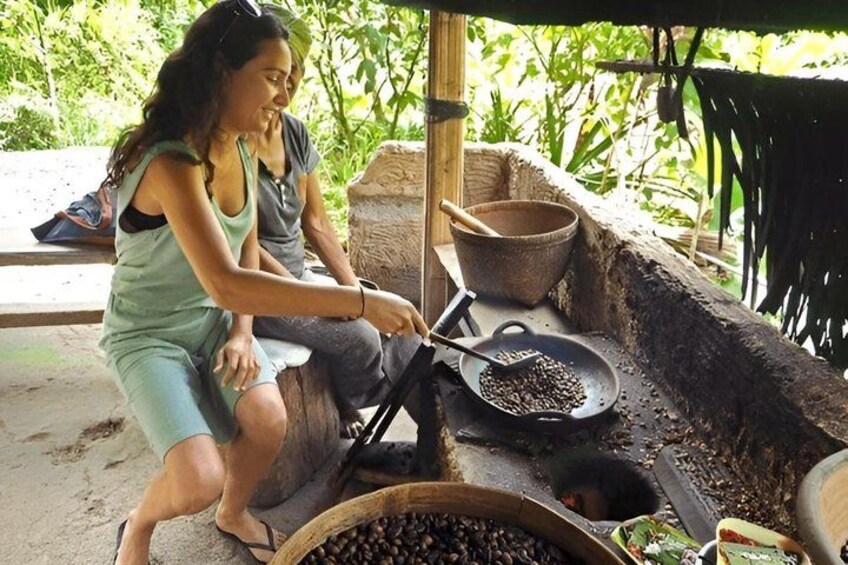 A person cooking outdoors using a traditional stove. 4