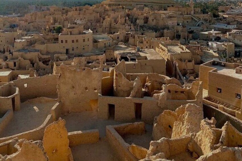 A densely packed village with traditional mud-brick buildings. 3