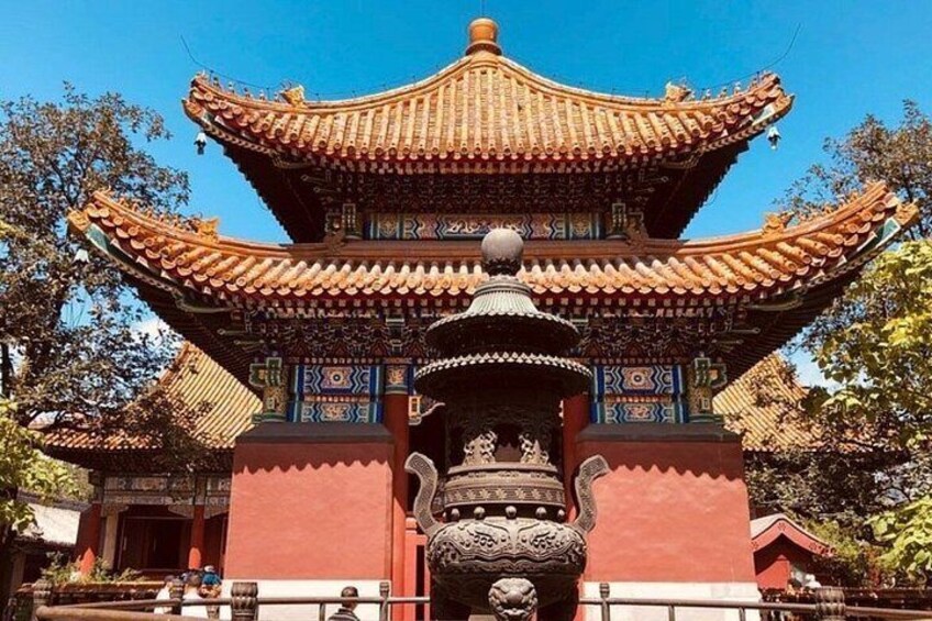 A traditional Chinese pagoda with ornate decorations and a central fountain. 4