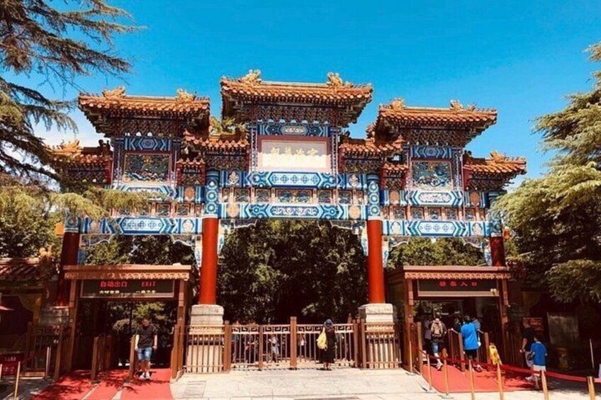 A traditional Chinese gate with intricate designs and multiple tiers. 5