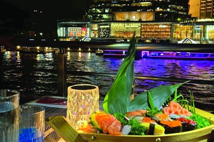 A sushi platter on a boat with a cityscape in the background. 3