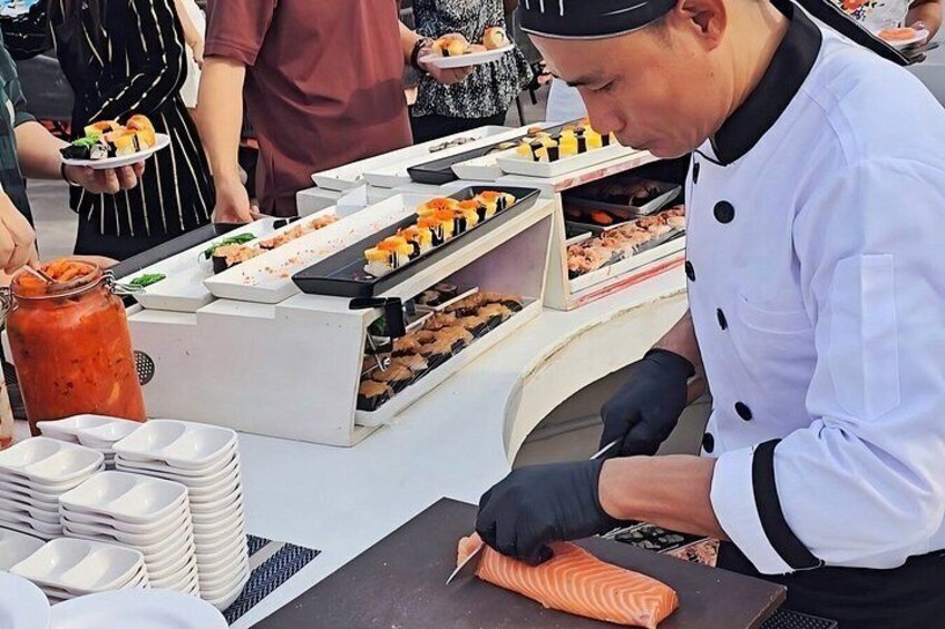 A chef preparing food, with a variety of dishes and a food display in the background. 3