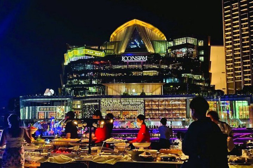 A brightly lit building with the name 'ICONSIAM' and a large yellow dome. 4