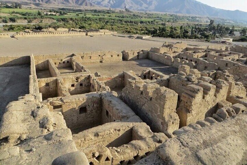 Ancient ruins with a large open area and distant mountains. 2