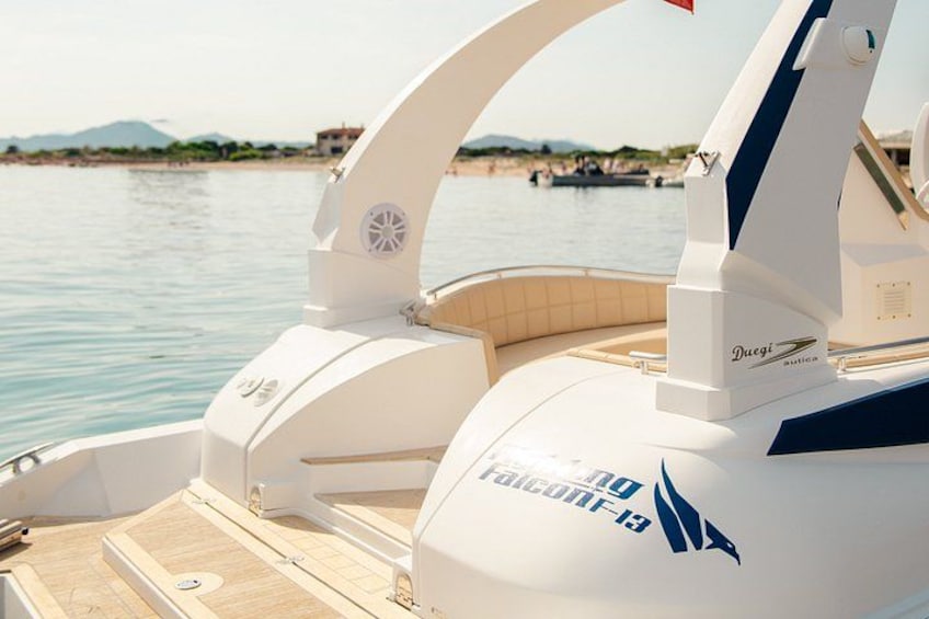A boat with a white and blue color scheme, a logo, and a name 'Ducati' on the side. 5