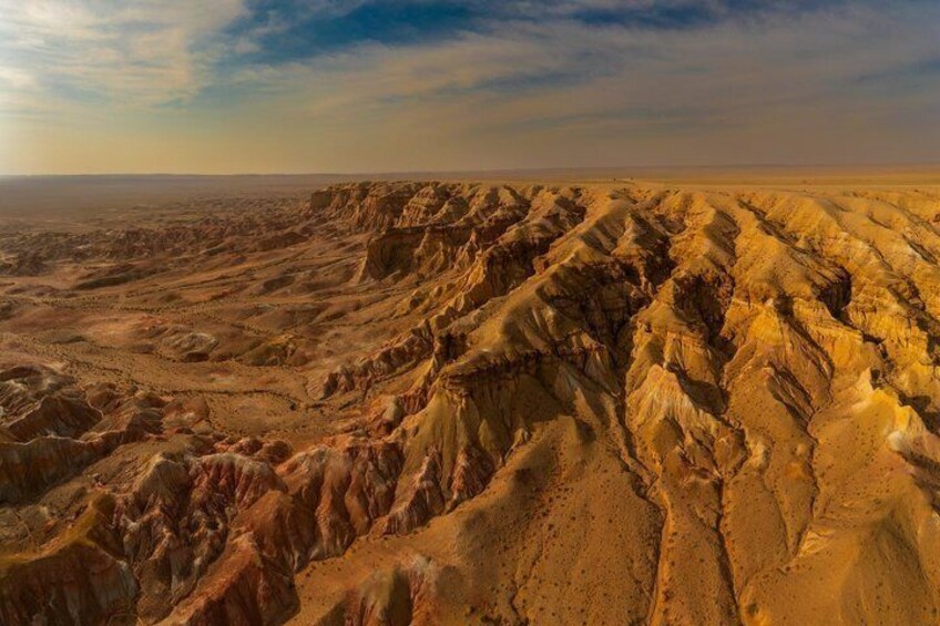 A vast desert landscape with rugged terrain and deep canyons. 5