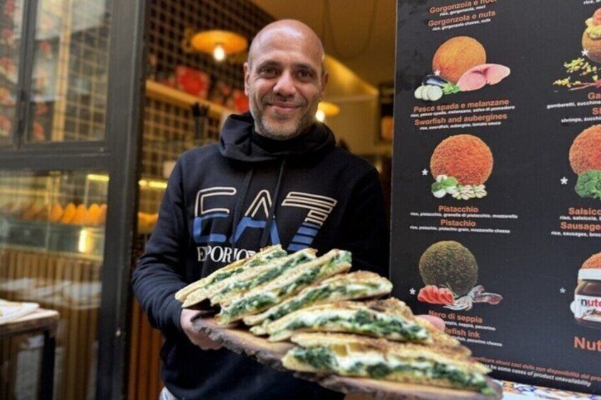 A person holding a tray of food items in a restaurant. 5