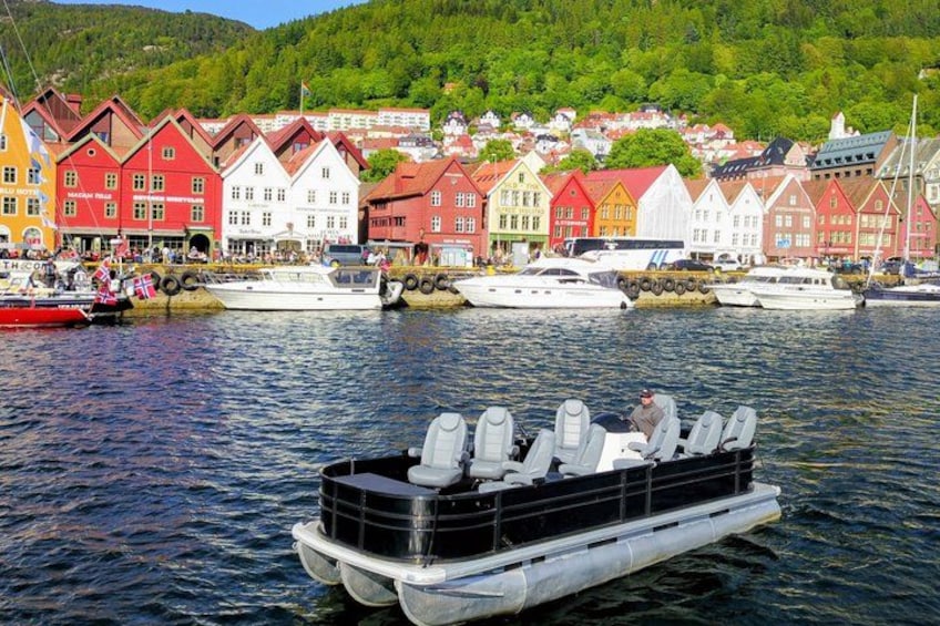 A colorful waterfront with boats and a row of traditional houses. 1