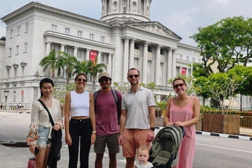 A group of people standing in front of a classical building with columns and a dome. 4