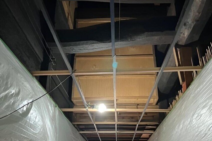 A construction site with exposed wooden beams and insulation material. 3