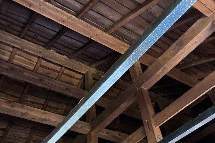 A wooden ceiling with metal beams. 2