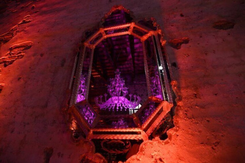 A hexagonal structure with a central purple light source, surrounded by a red glow. 2