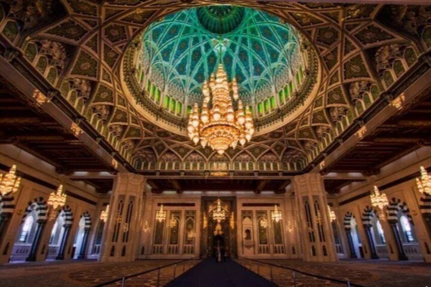 An ornate interior with a large dome and chandeliers. 5