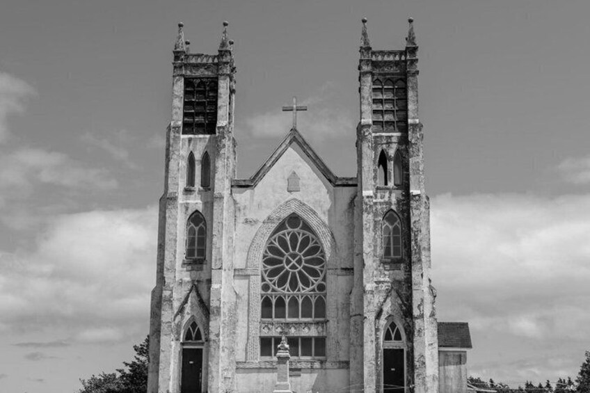 A Gothic-style church with twin towers and a large rose window. 1