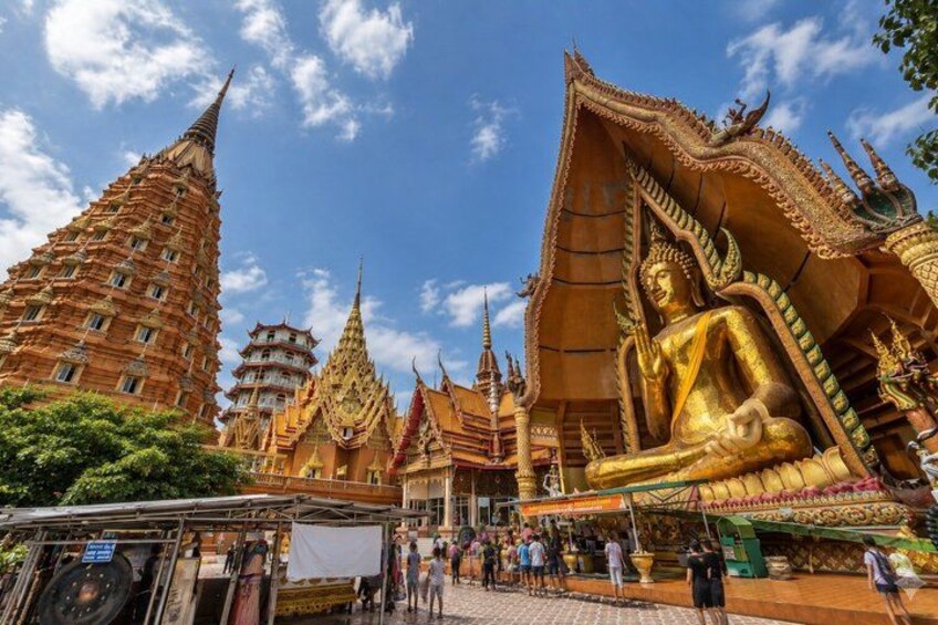 A large golden Buddha statue, traditional Thai architecture, and a multi-tiered pagoda. 4