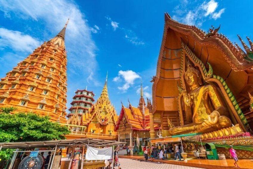 A temple with golden spires and a large golden statue. 4