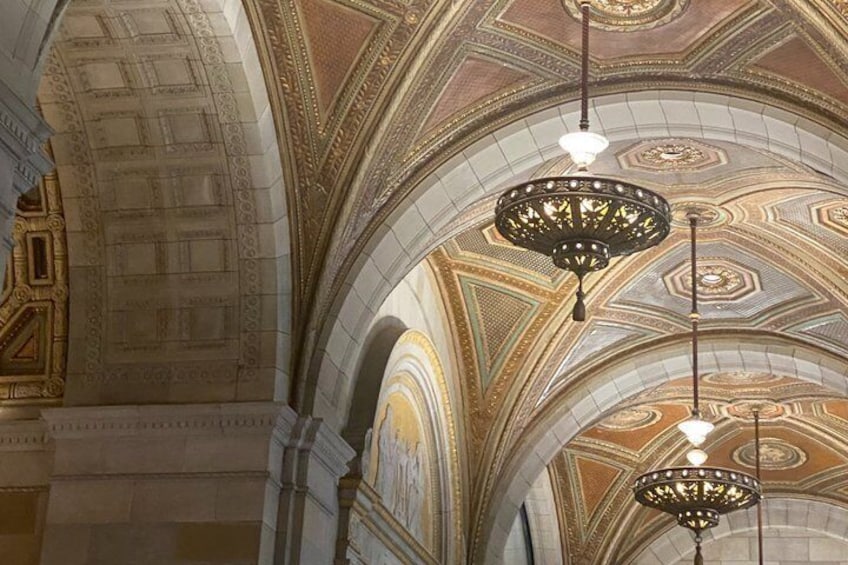 A grand interior with ornate ceiling and chandeliers. 3
