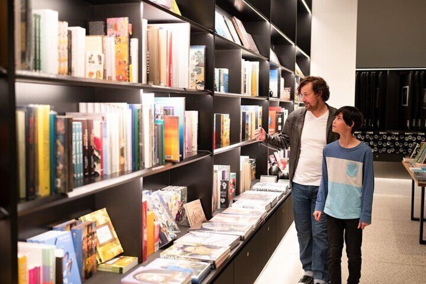 A bookstore with bookshelves and a display table. 5