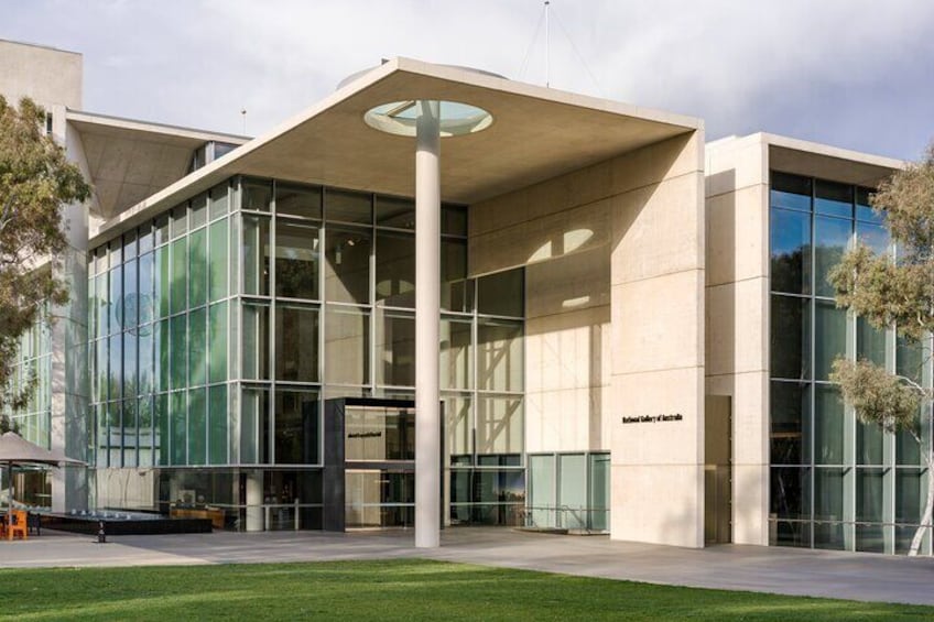 A modern building with large glass windows and a central column. 2