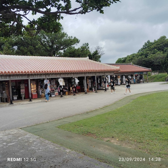 Un mercado tradicional con techo de azulejos, varios puestos y gente caminando. 2