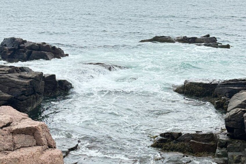 A rocky coastline with waves crashing against the rocks. 3