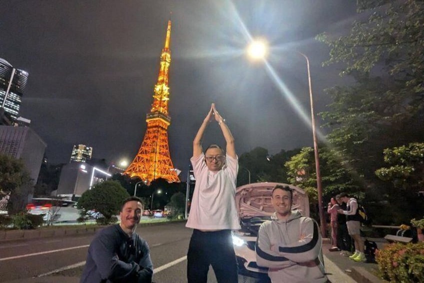 Three people standing on a street with the Eiffel Tower in the background. 5