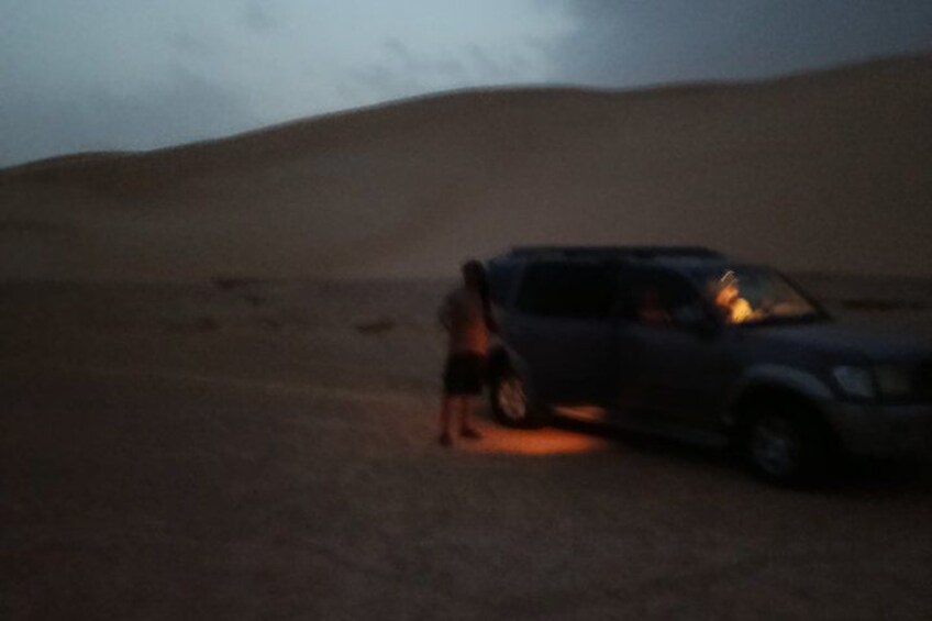 A desert landscape with a vehicle and a person. 5