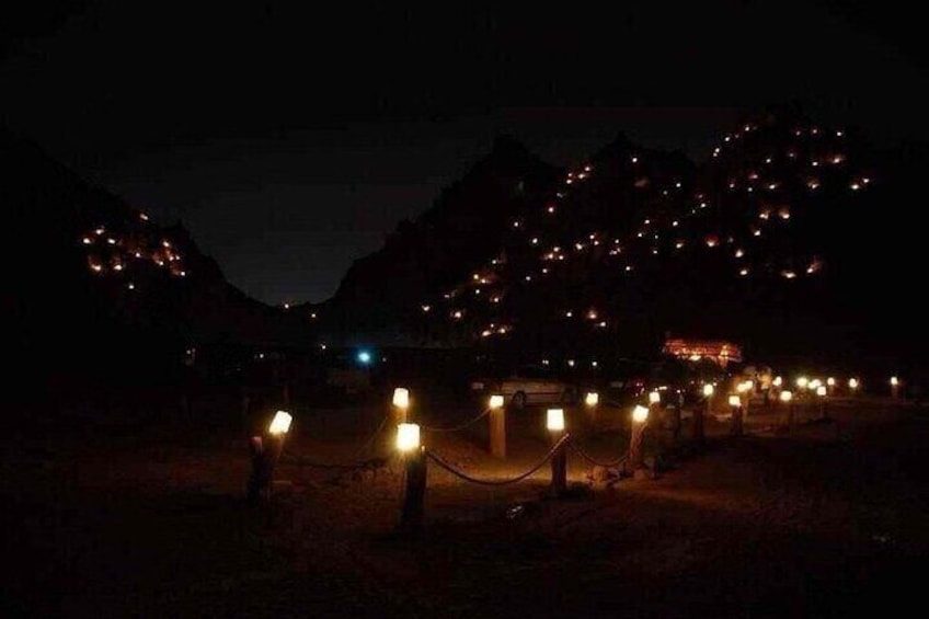 A nighttime scene with a series of lights in a mountainous area, possibly a resort or tourist attraction. 4