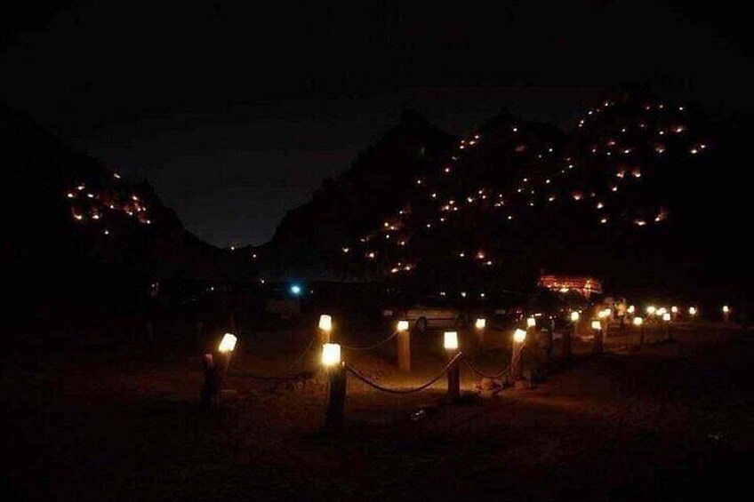A nighttime scene with a series of lights in a mountainous area, possibly indicating a resort or tourist attraction. 4