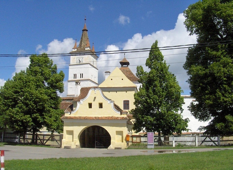 A church with a bell tower and a large arched entrance. 1