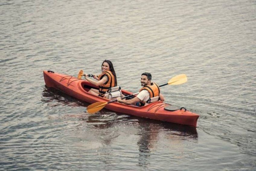 Two people kayaking on calm water. 4
