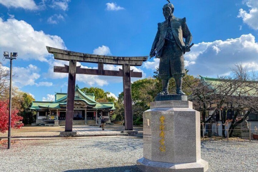 A statue, a torii gate, and a traditional building. 3