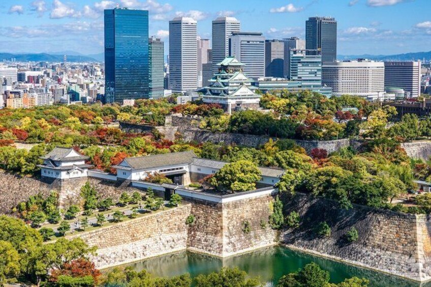 A cityscape with traditional Japanese architecture, including a castle and a modern skyline. 2