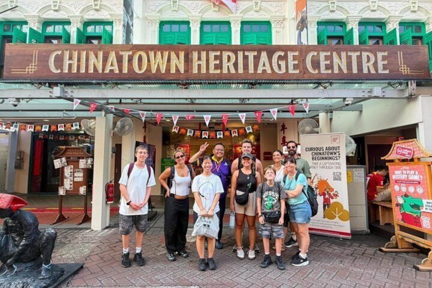 A group of people standing in front of the Chinatown Heritage Centre. 2