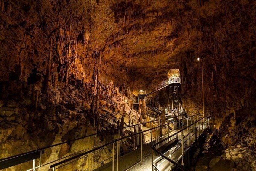 A cave with stalactites, a viewing platform, and a staircase. 2