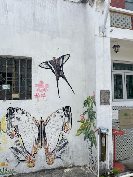 A building with a mural of a butterfly and a dragonfly. 3