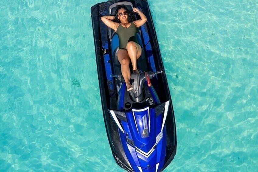 A person on a jet ski in a clear blue pool. 4