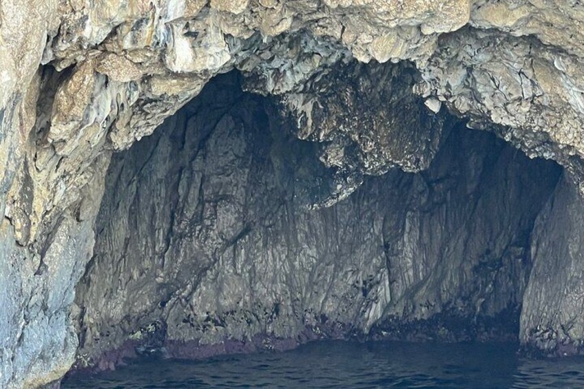 A cave entrance with rugged rock walls and a dark interior. 4