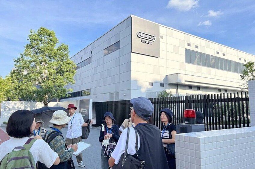 A group of people standing outside a modern building with a sign that reads 'Chilterns.' 2