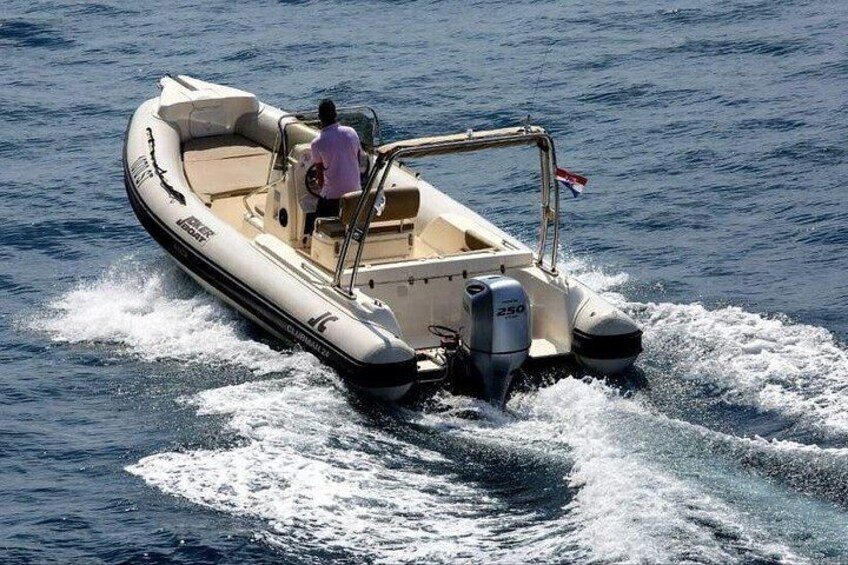 A motorboat on water with a person steering. 4