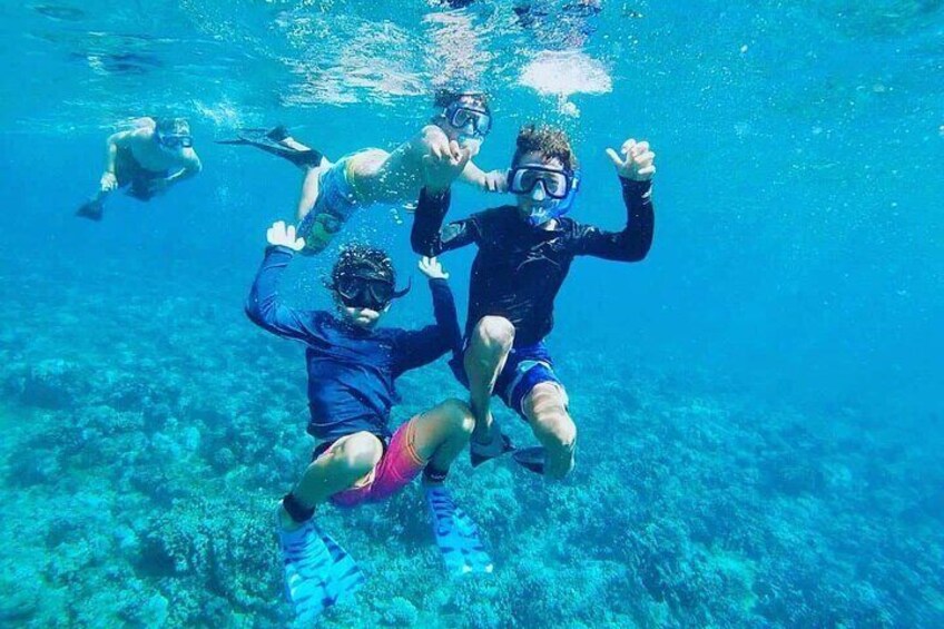 People snorkeling underwater. 1
